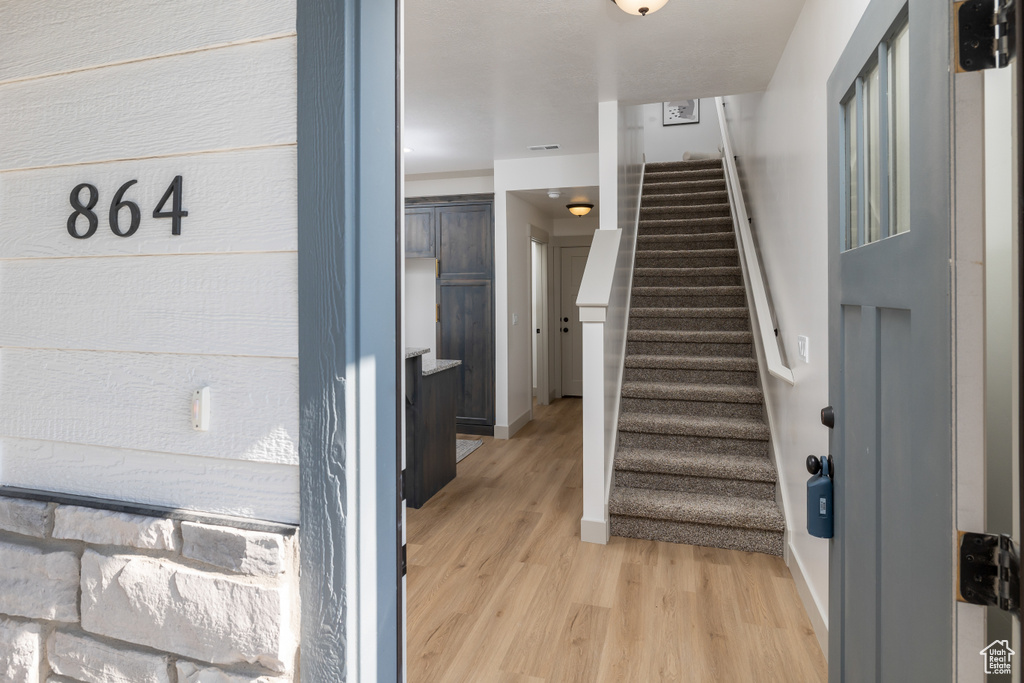 Stairs featuring baseboards and wood finished floors