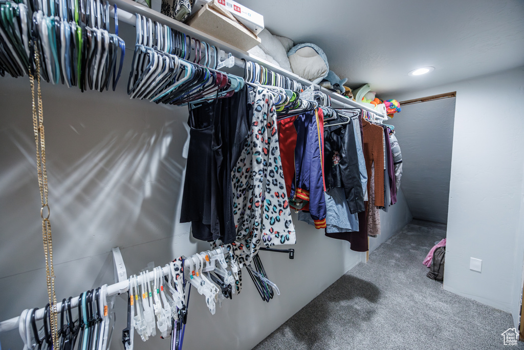 Walk in closet with carpet floors