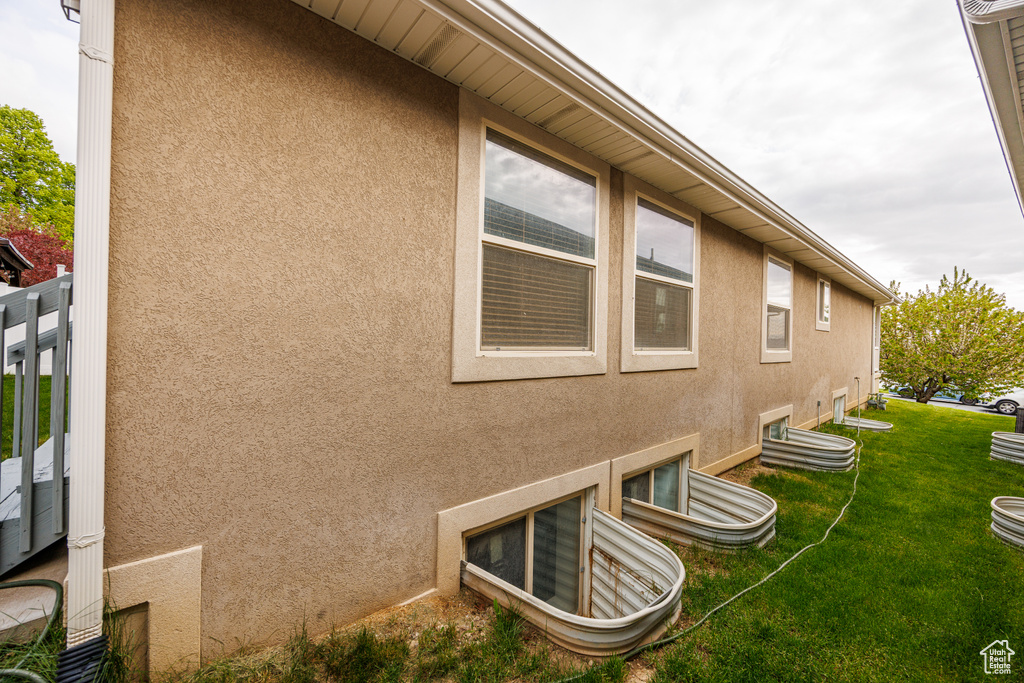View of home's exterior with a lawn and stucco siding