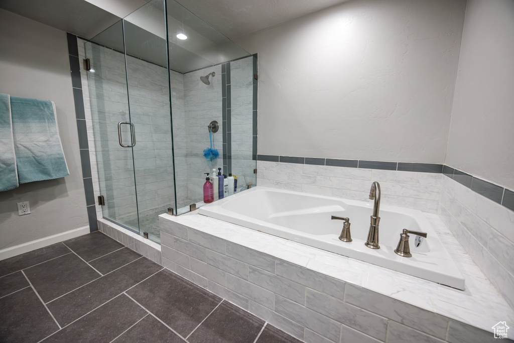Full bath with a garden tub, tile patterned floors, and a shower stall
