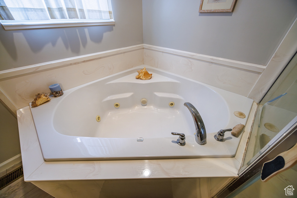 Full bathroom with a jetted tub