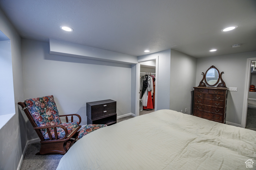 Carpeted bedroom featuring recessed lighting, baseboards, and a spacious closet