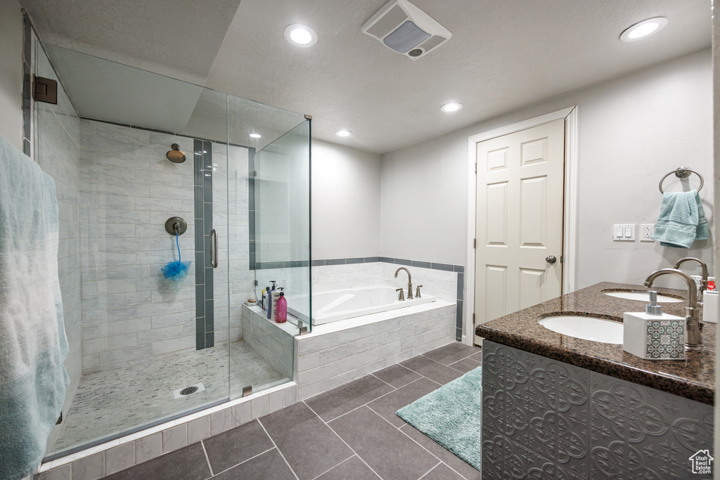 Full bathroom with recessed lighting, tile patterned floors, a shower stall, and a garden tub