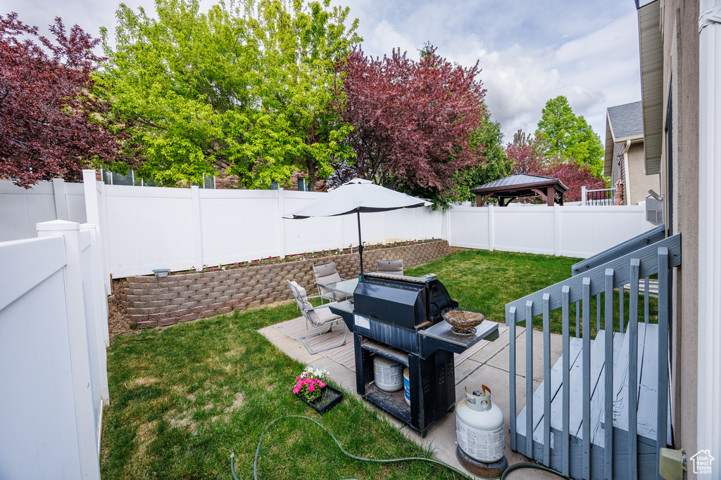View of yard featuring a fenced backyard, a gazebo, and a patio area