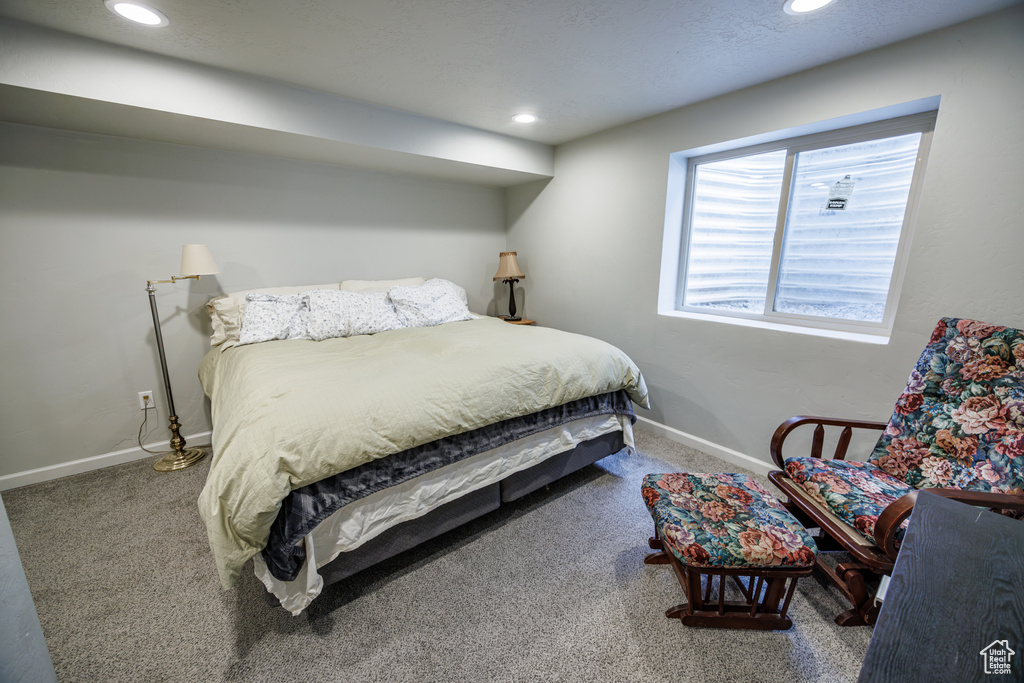 Carpeted bedroom with baseboards and recessed lighting