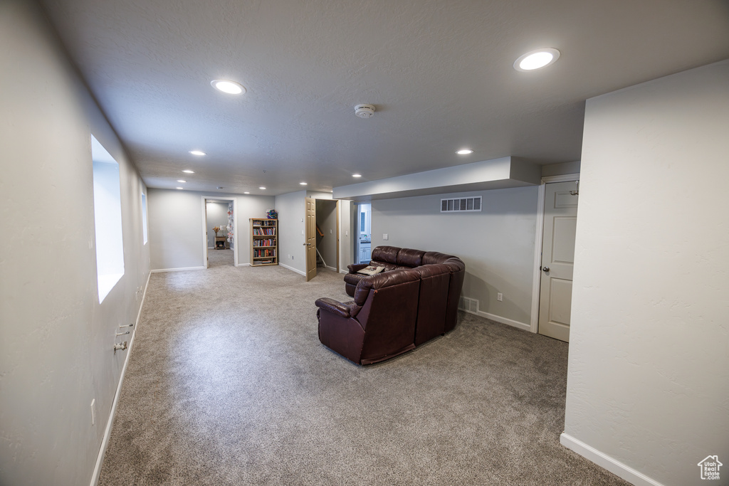 Living room with carpet flooring, recessed lighting, and baseboards