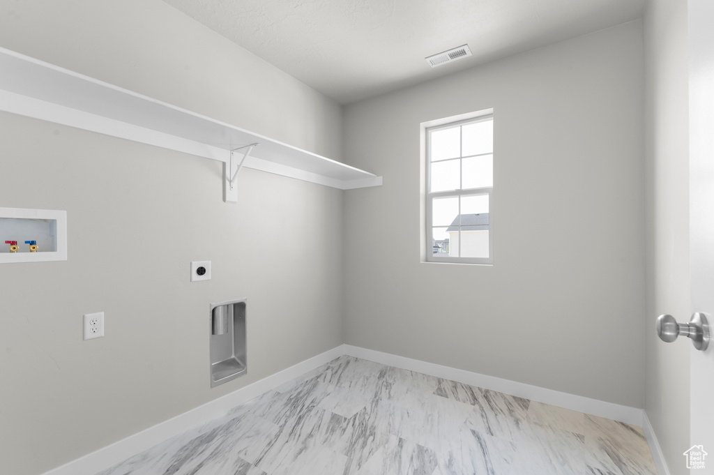Washroom featuring hookup for a washing machine, baseboards, light marble finish floors, and electric dryer hookup