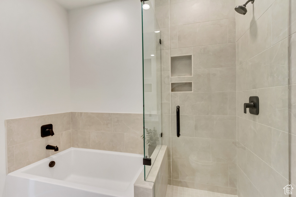 Full bath featuring a shower stall and a bath