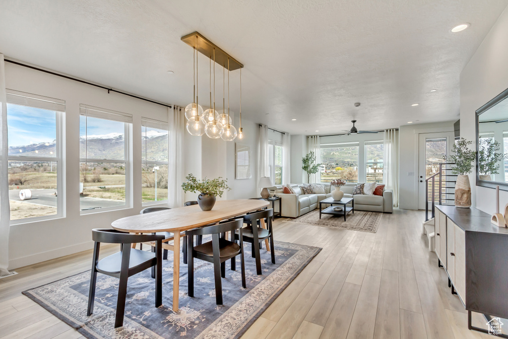 Dining area featuring a ceiling fan, recessed lighting, a mountain view, and light wood-type flooring