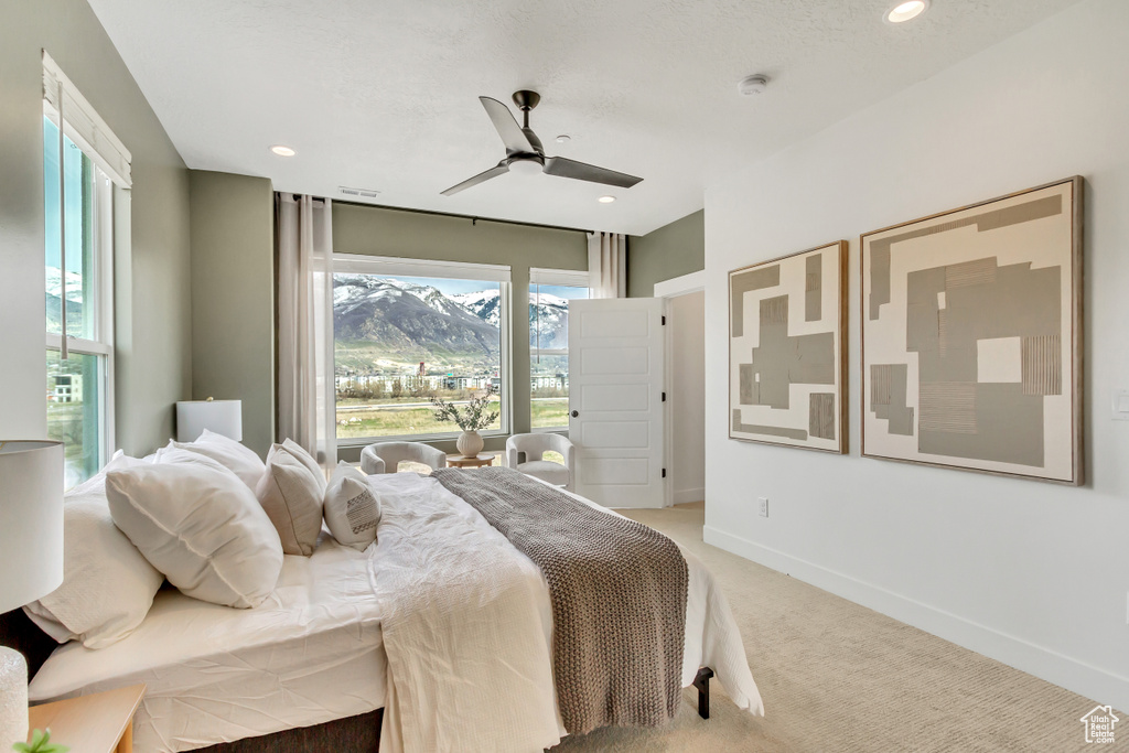Bedroom with baseboards, ceiling fan, light carpet, and recessed lighting