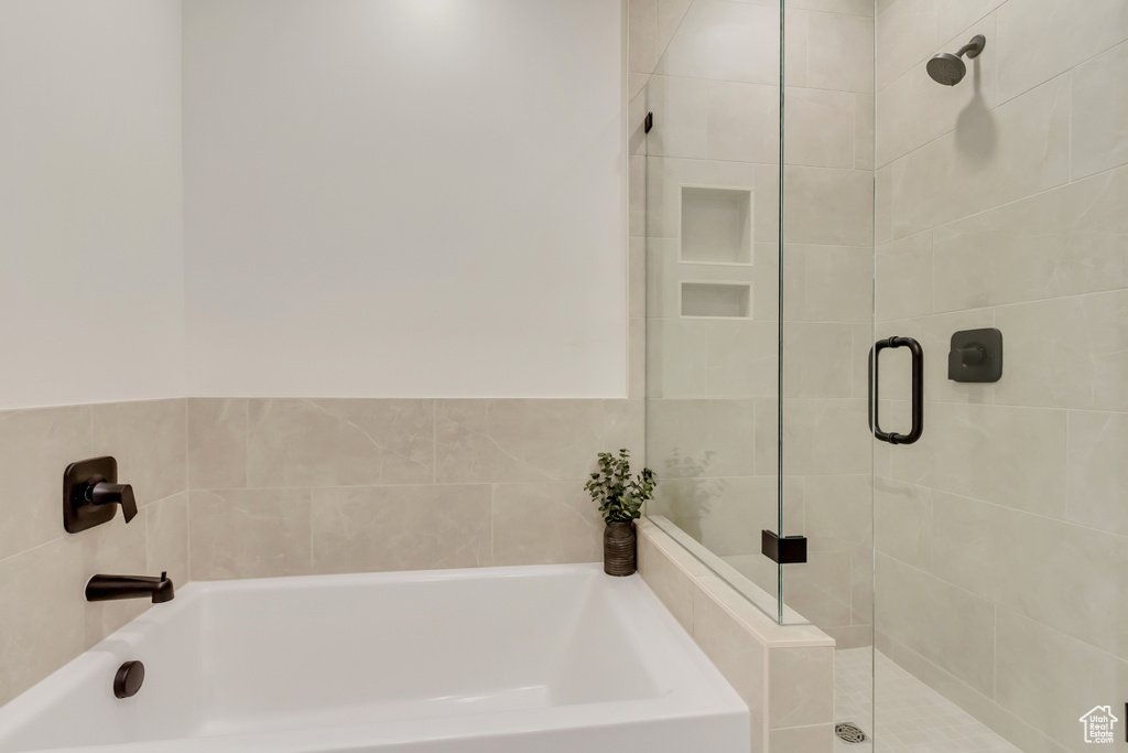 Bathroom with a garden tub and a stall shower