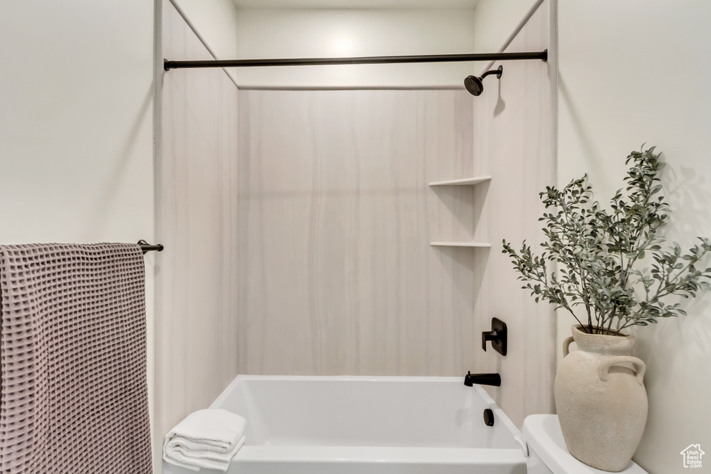 Full bath featuring toilet and tub / shower combination