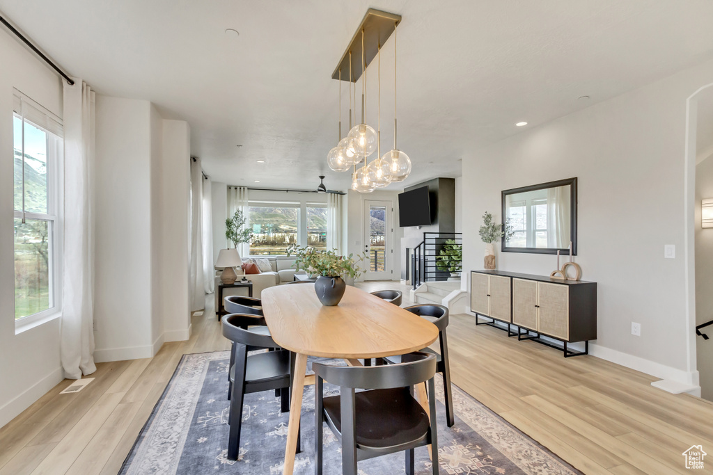 Dining area featuring baseboards, an inviting chandelier, visible vents, and light wood-type flooring