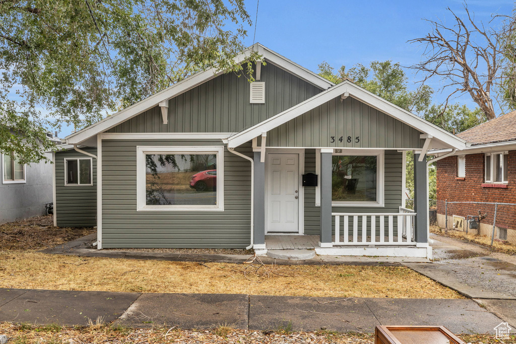 Bungalow-style house with a porch and board and batten siding