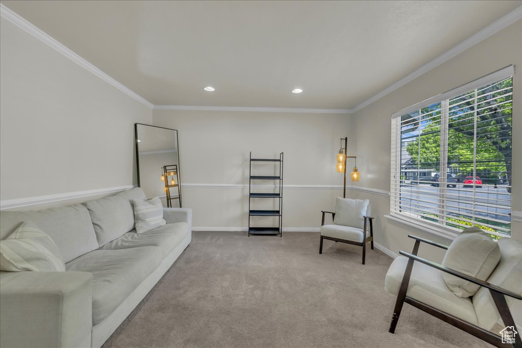 Living room with crown molding, recessed lighting, baseboards, and light carpet
