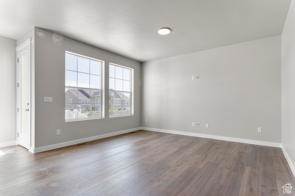 Unfurnished room featuring wood-type flooring and baseboards