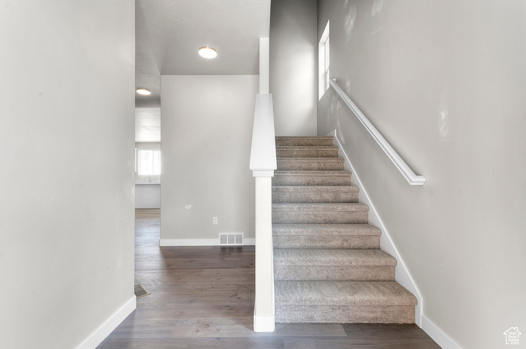 Stairs featuring baseboards and wood finished floors