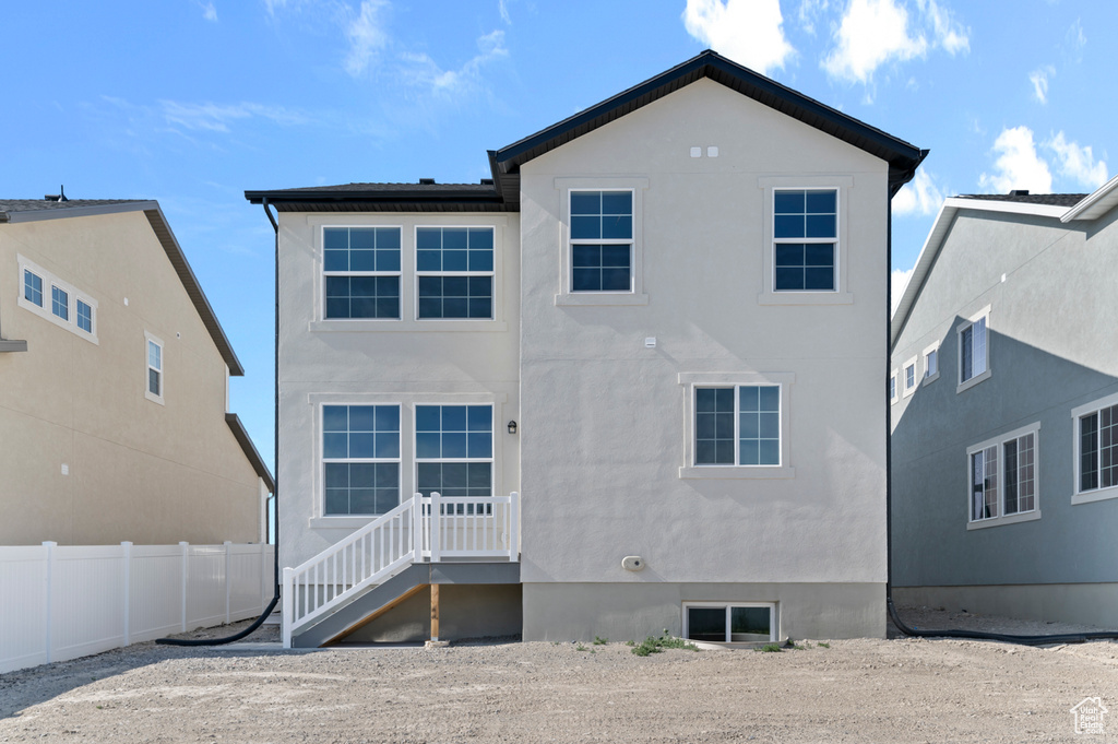Back of house featuring stucco siding