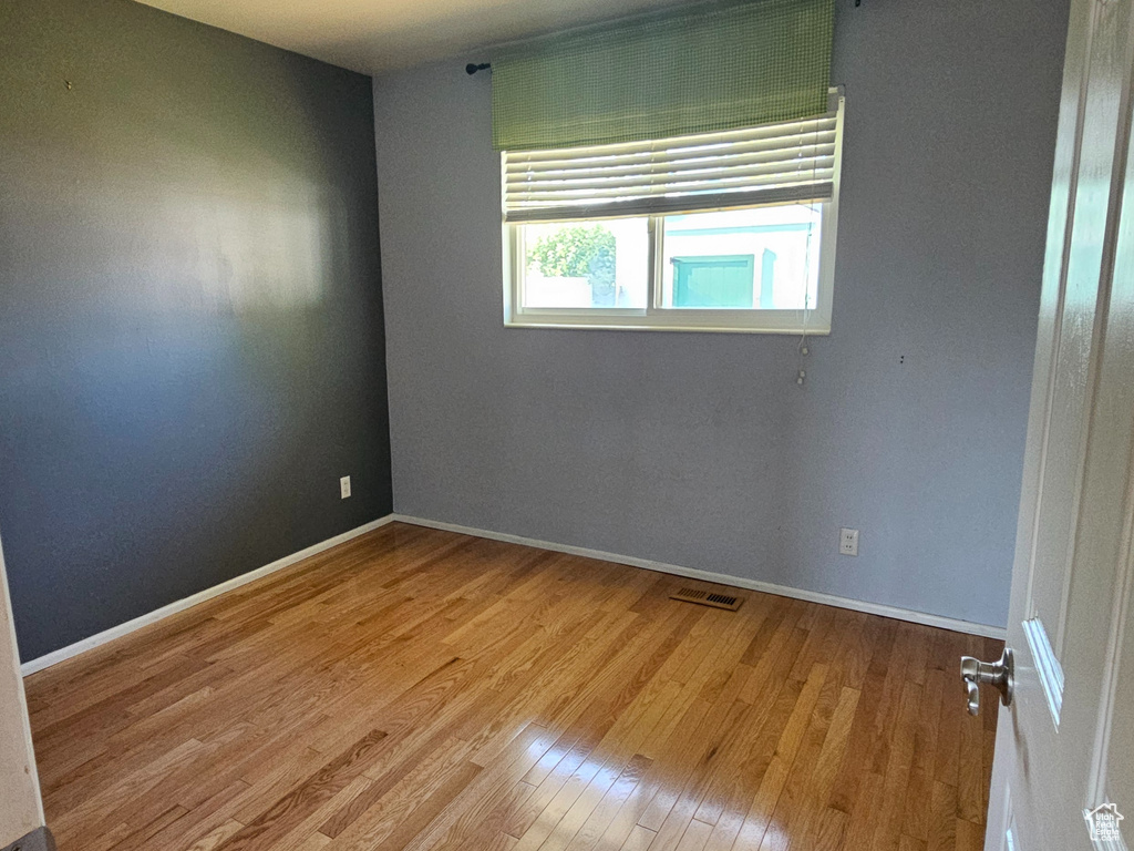 Spare room with wood finished floors and baseboards