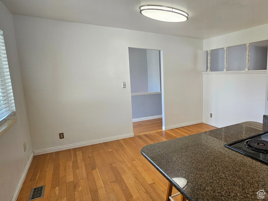 Kitchen featuring range, light wood-type flooring, brown cabinetry, and a peninsula