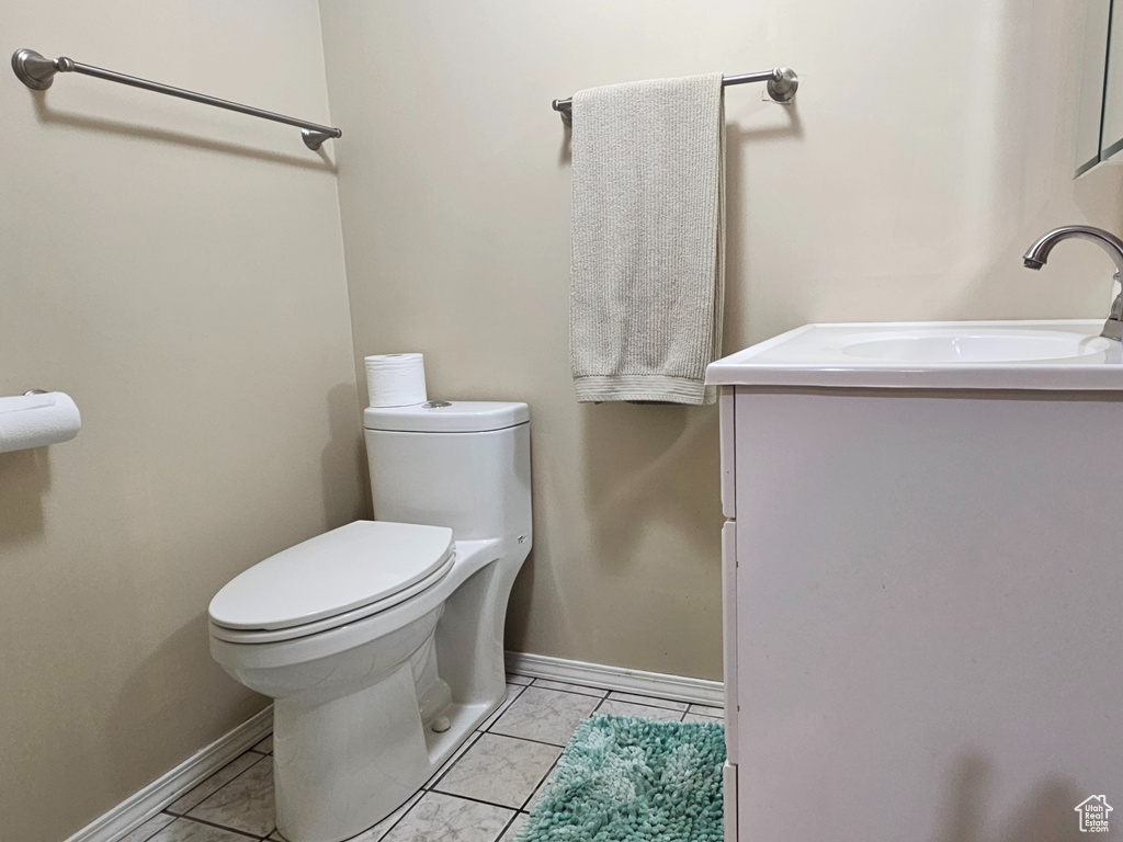 Half bath with vanity and tile patterned floors