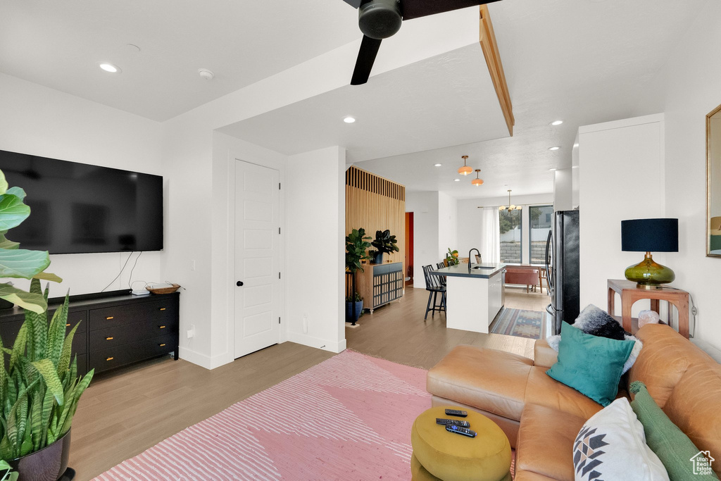 Living area featuring light wood-type flooring, recessed lighting, baseboards, and a ceiling fan