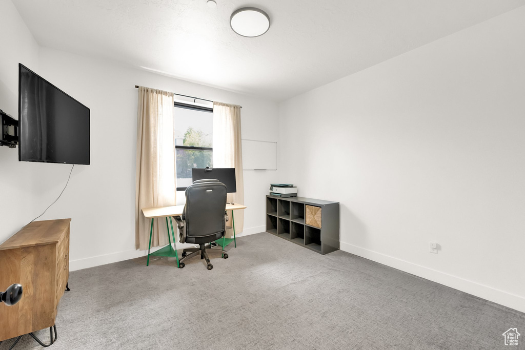 Carpeted home office with baseboards