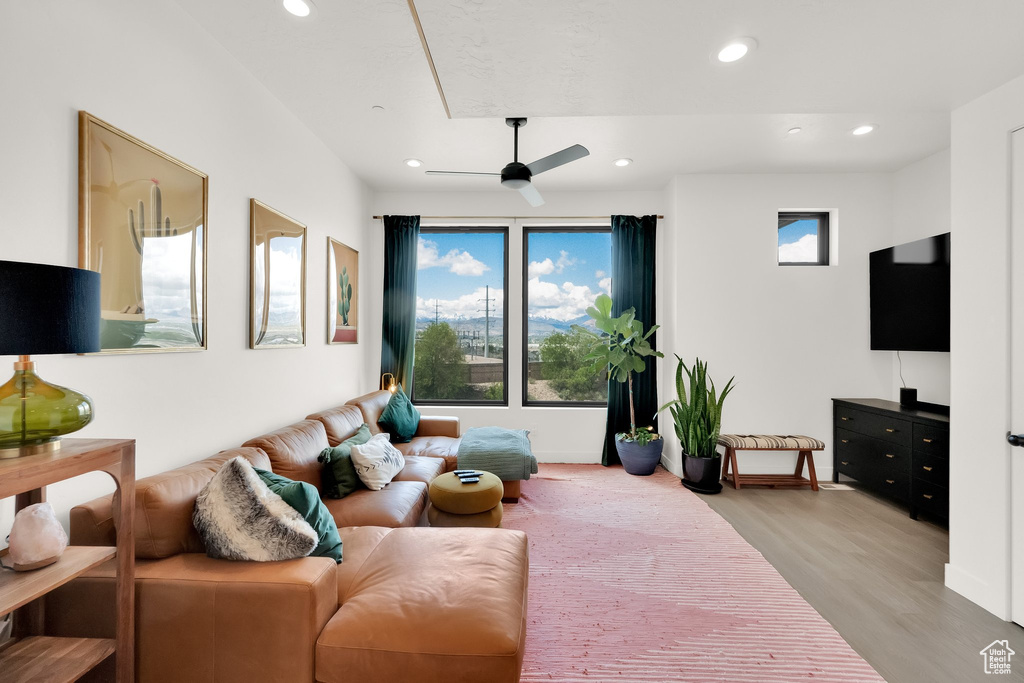 Living area featuring recessed lighting, a ceiling fan, baseboards, and light wood-style floors