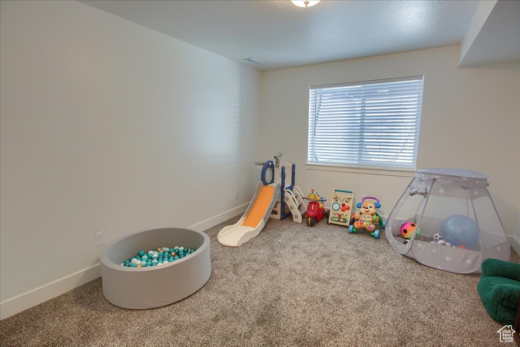 Game room featuring visible vents, carpet, and baseboards