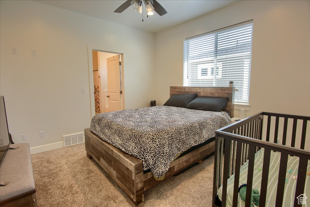 Bedroom featuring visible vents, carpet, ceiling fan, and baseboards
