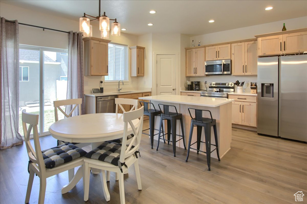 Dining area featuring recessed lighting, light wood-style floors, a chandelier, and baseboard heating