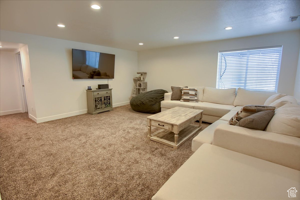 Living area featuring carpet flooring, recessed lighting, baseboards, and visible vents