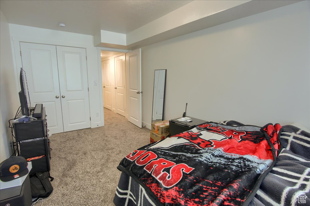 Carpeted bedroom with a closet