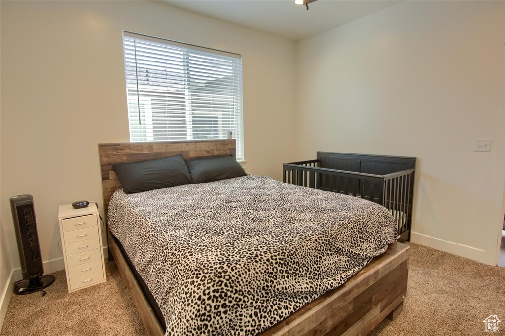 Bedroom with carpet floors and baseboards