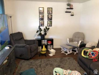 Living room featuring baseboards and wood finished floors