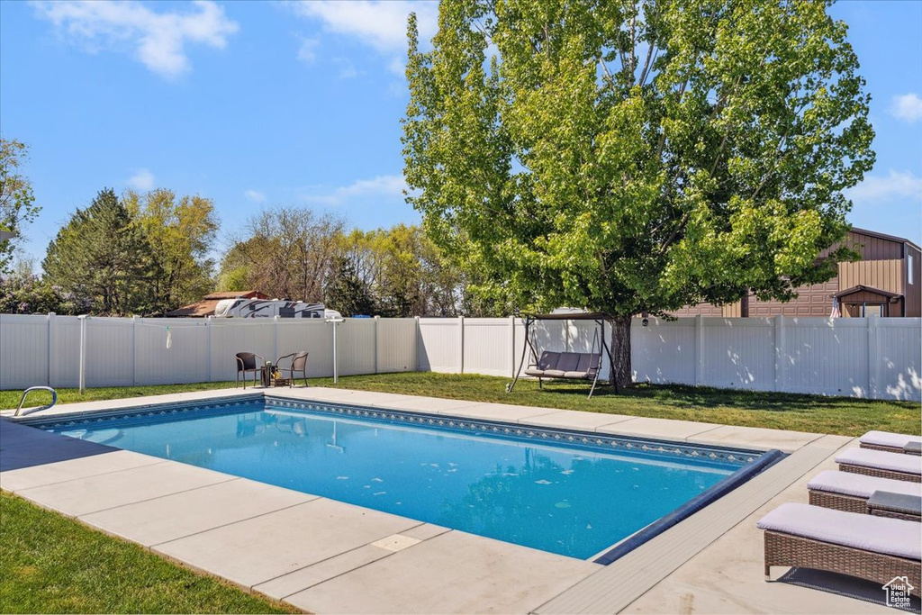 View of swimming pool featuring a fenced in pool, a lawn, and a fenced backyard