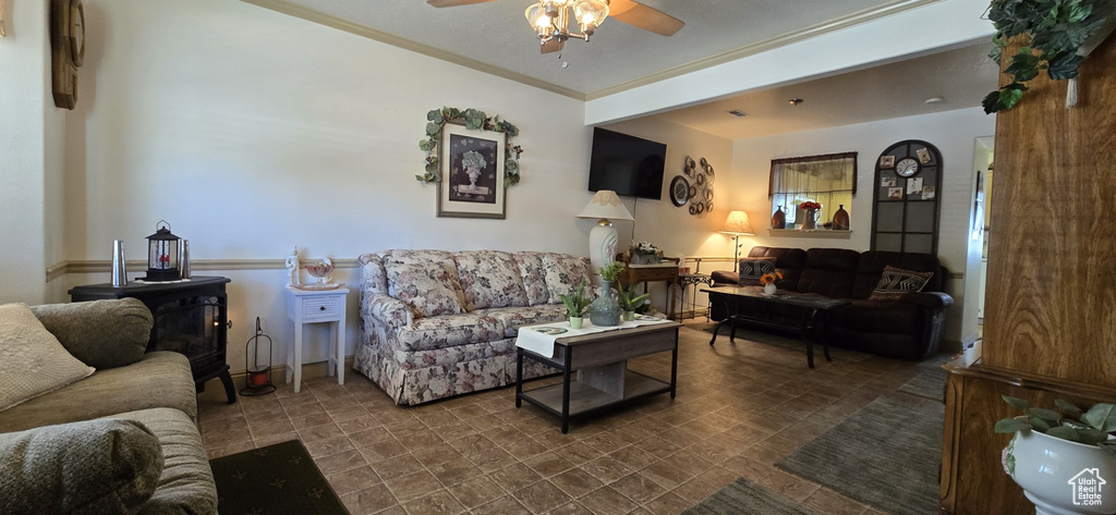 Living area with ornamental molding and a ceiling fan