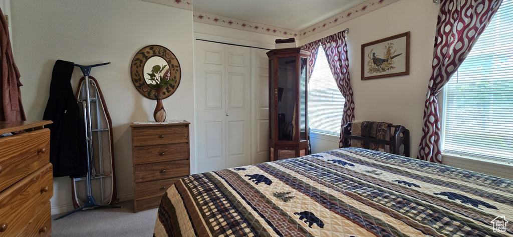 Bedroom with carpet and a closet