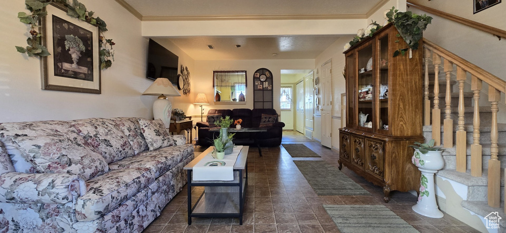 Living room with stairs and ornamental molding