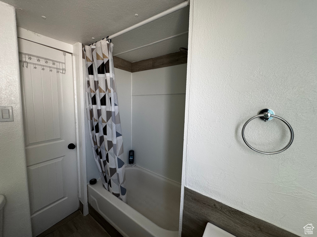 Full bathroom featuring shower / bathtub combination with curtain