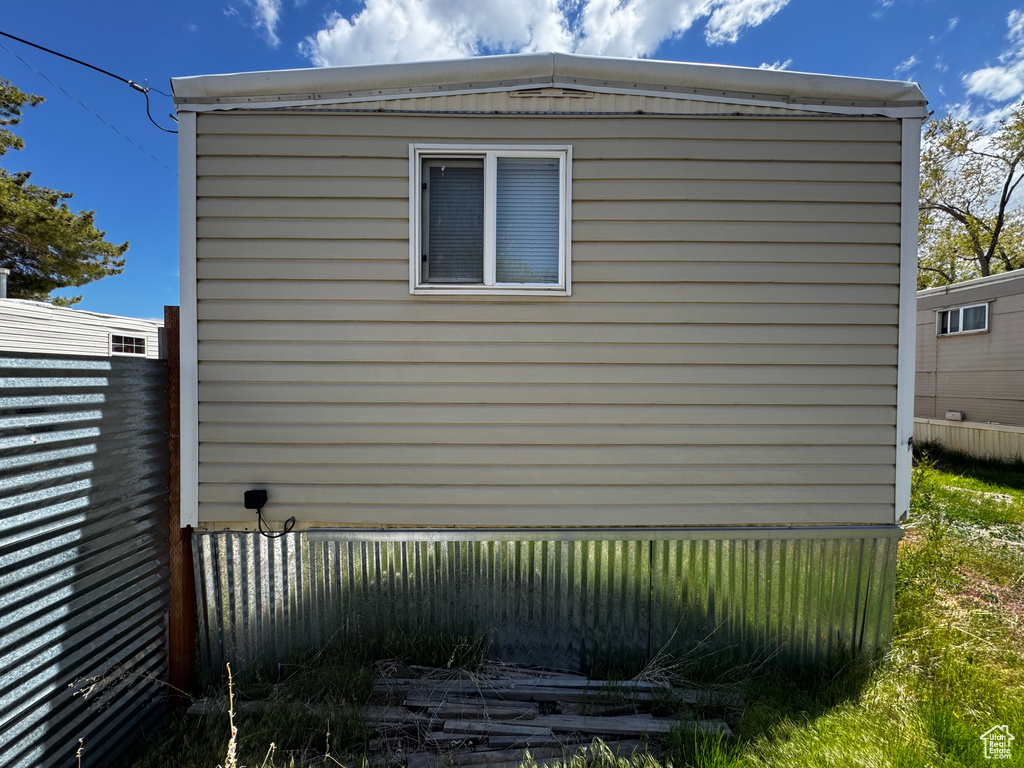 View of side of home featuring fence