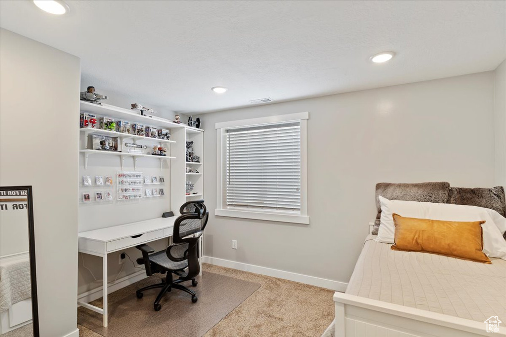 Carpeted bedroom with visible vents, recessed lighting, and baseboards
