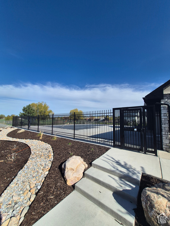 View of gate featuring fence