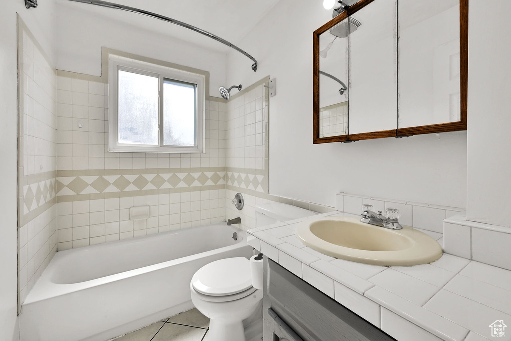 Full bathroom featuring vanity, tile patterned floors, shower / bathtub combination, and toilet