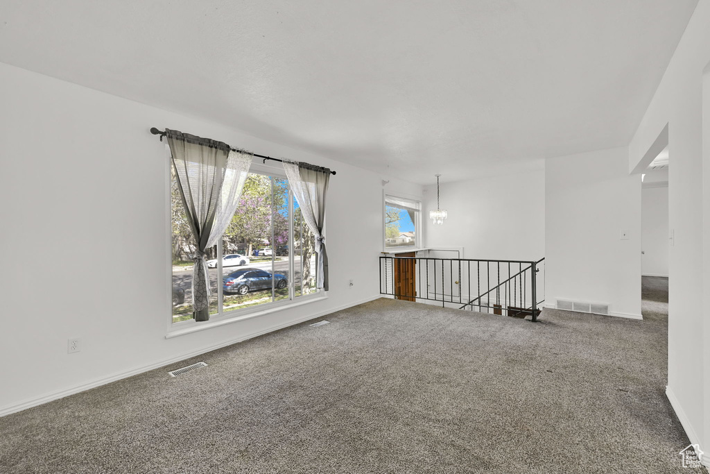 Spare room with baseboards, carpet flooring, and visible vents
