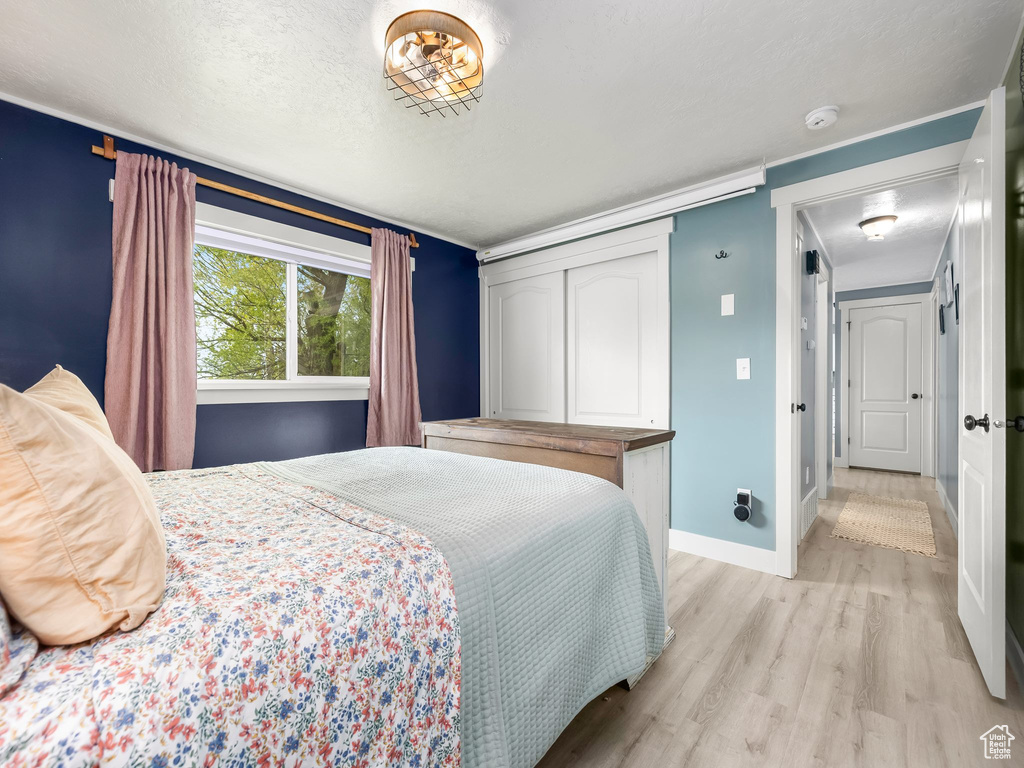 Bedroom featuring baseboards and light wood finished floors