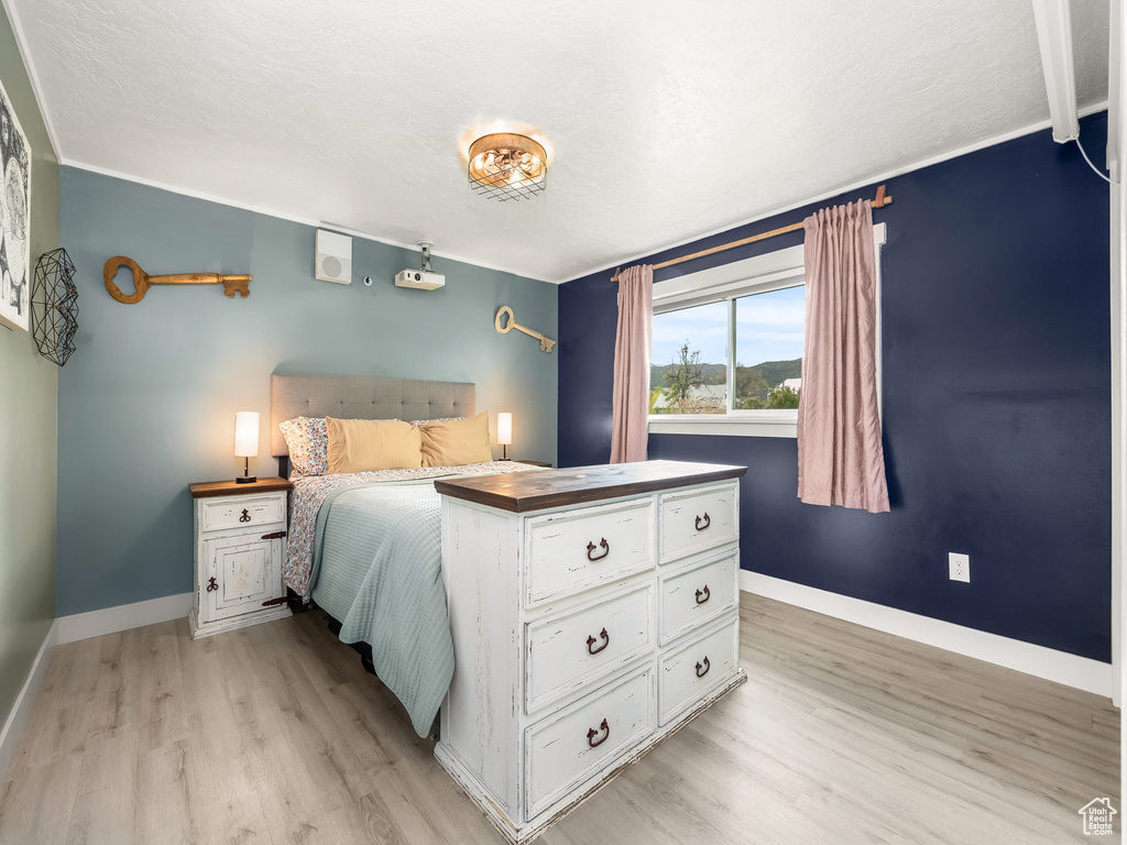 Bedroom featuring light wood-type flooring and baseboards
