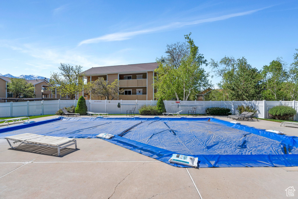Pool with fence and a patio area