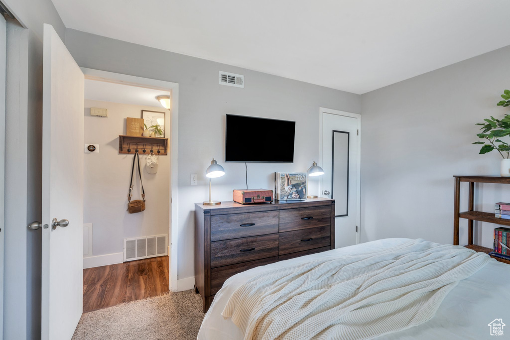 Bedroom featuring baseboards, visible vents, and carpet