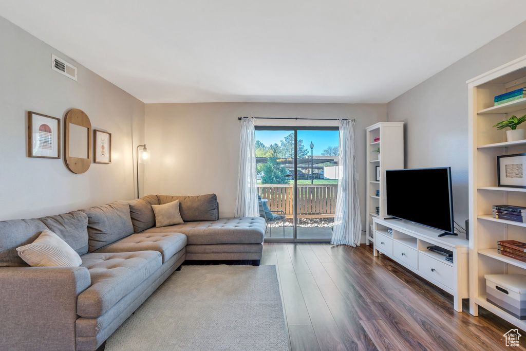 Living room with dark wood finished floors and visible vents